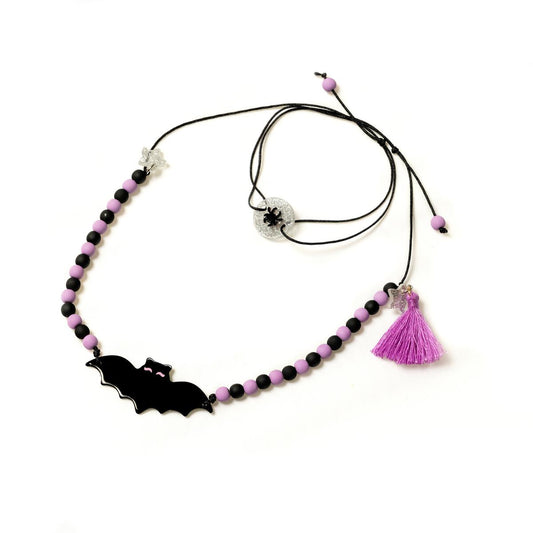 Necklace with bat charm and tassel on a white background