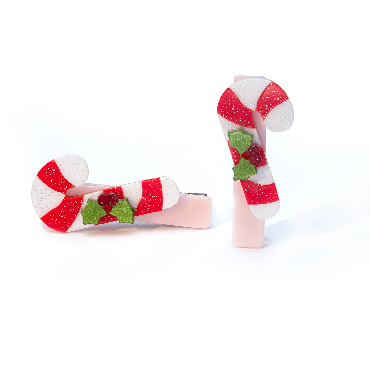 Two candy cane-shaped hair clips on a white background