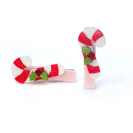 Two candy cane-shaped hair clips on a white background