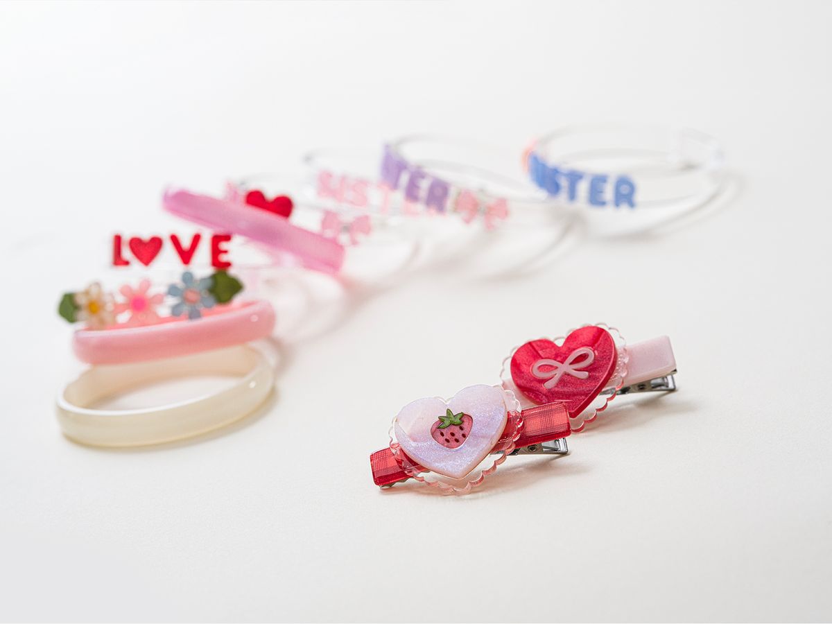 Set of colorful hair clips with heart designs on a white background