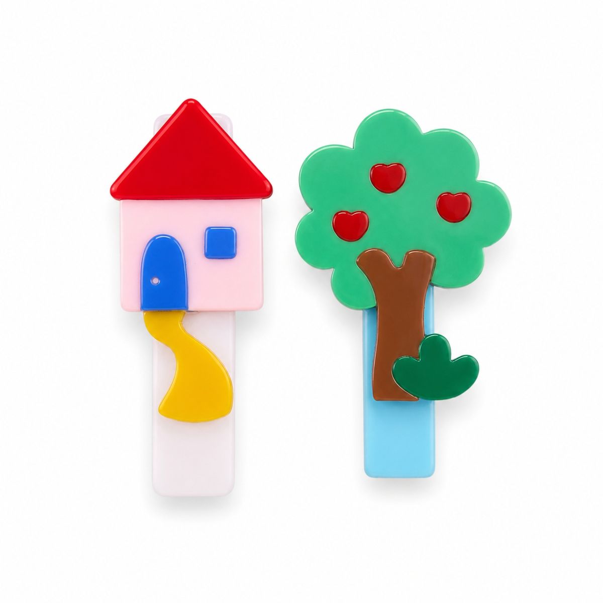 Two colorful hair clips shaped like a house and a tree, shown on a plain white background.