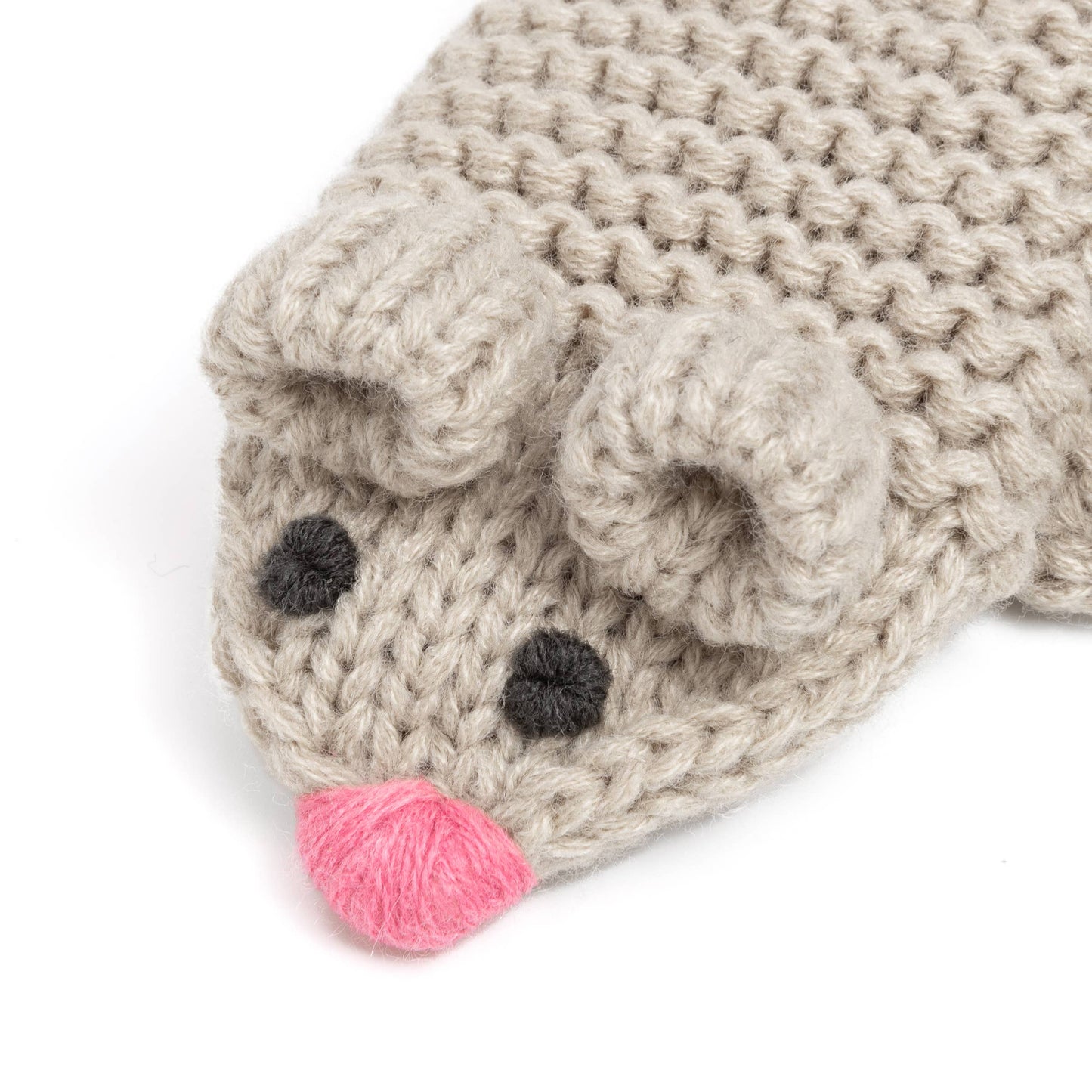 Knitted animal hat with a pink nose on a white background