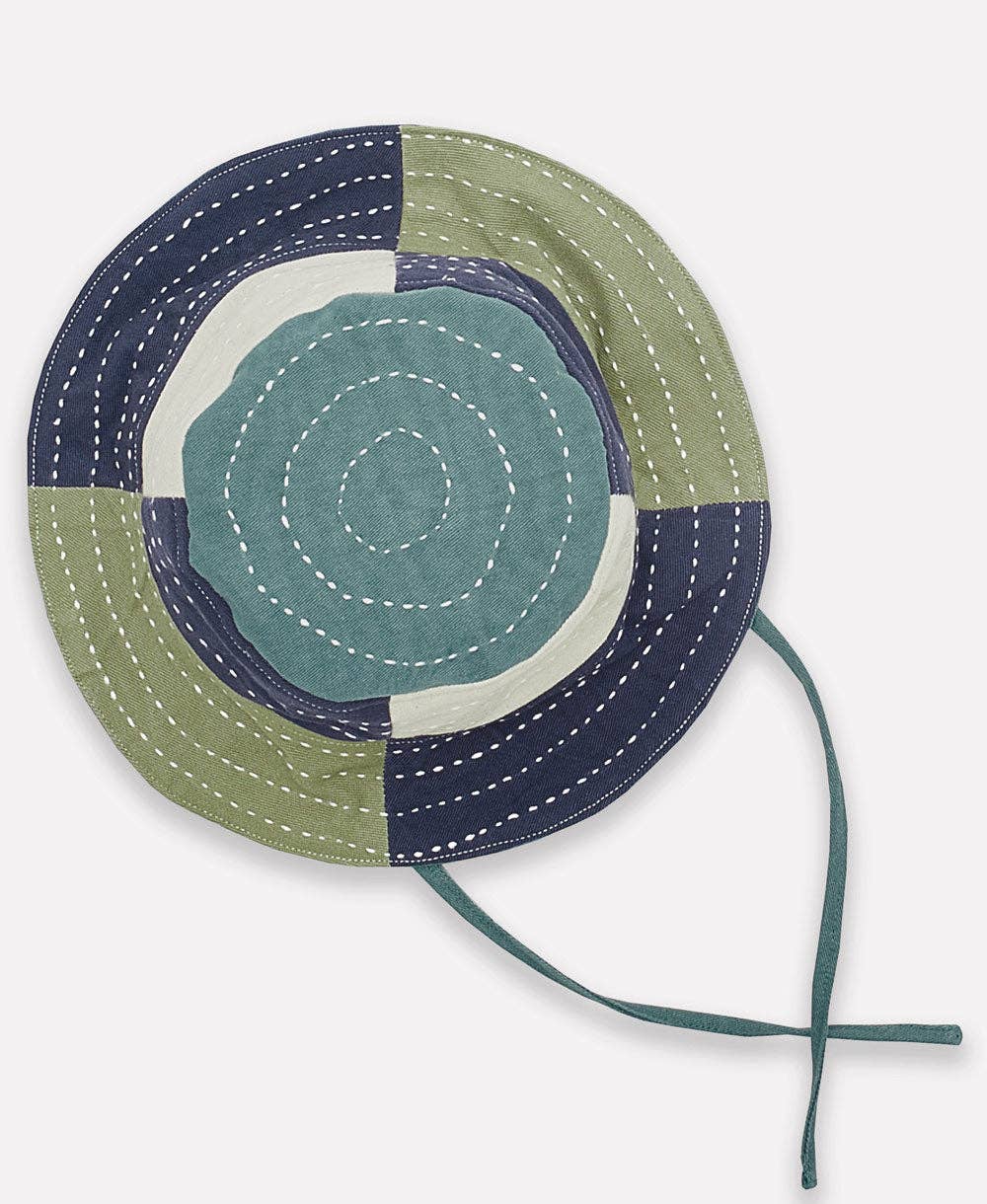 Color-blocked bucket hat with green, blue, and beige sections on a white background