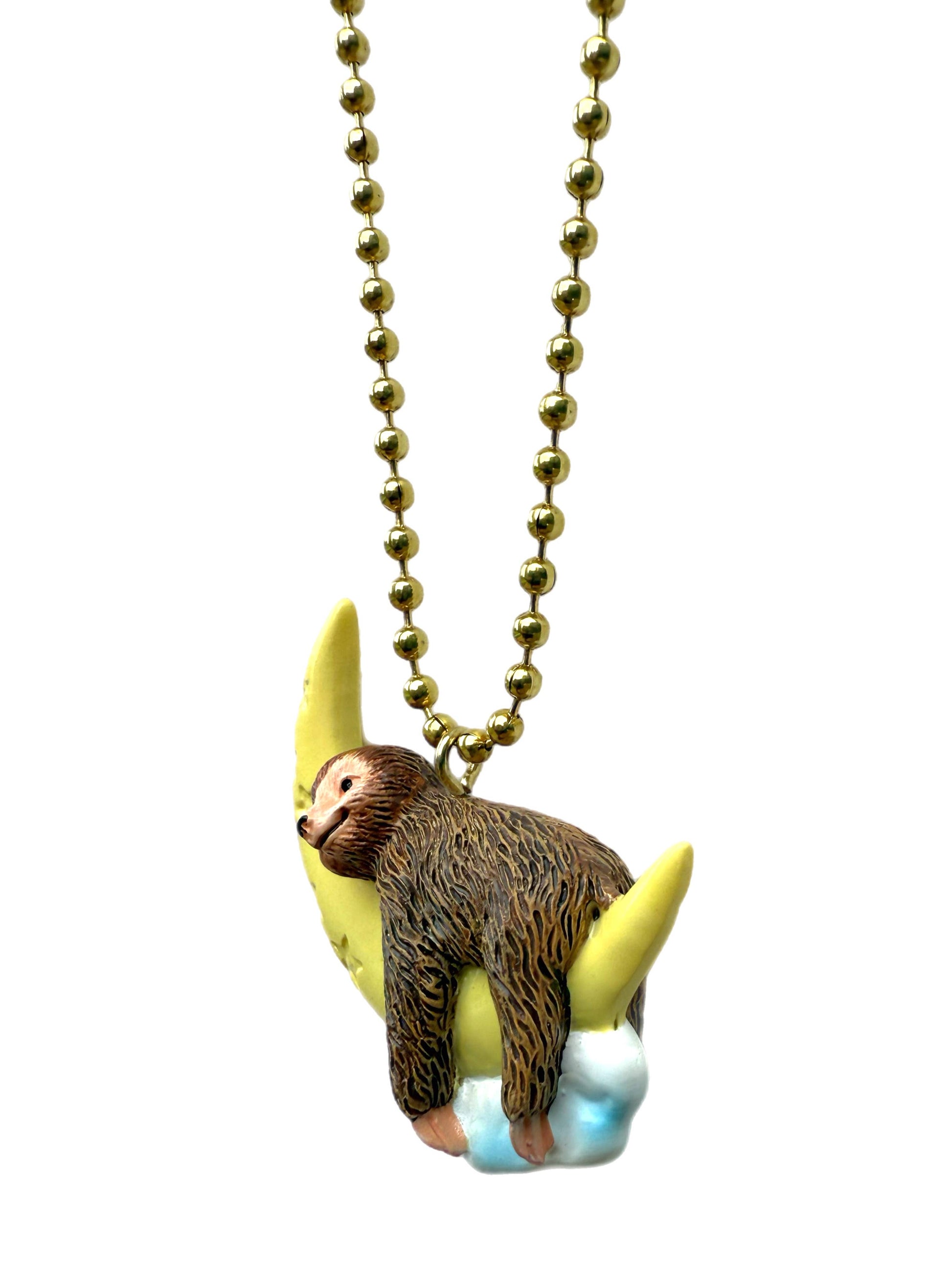 Necklace with a sloth figurine pendant on a white background