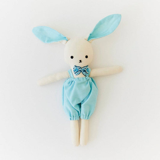 Toy rabbit with blue outfit and ears on a white background