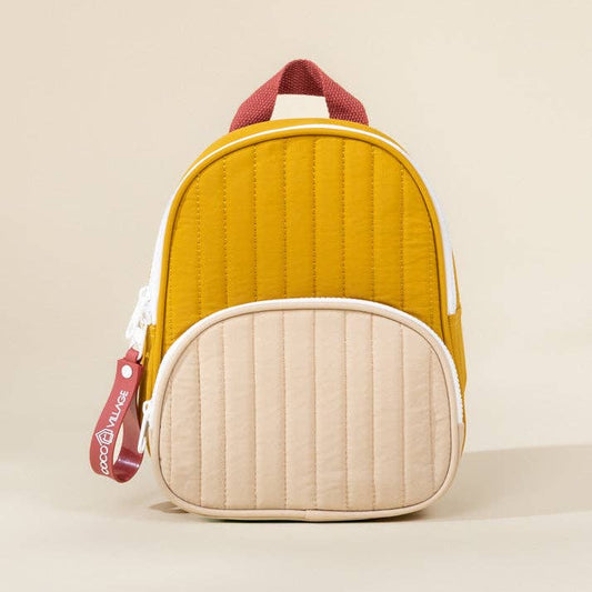 Yellow and beige quilted backpack with red accents on a beige background