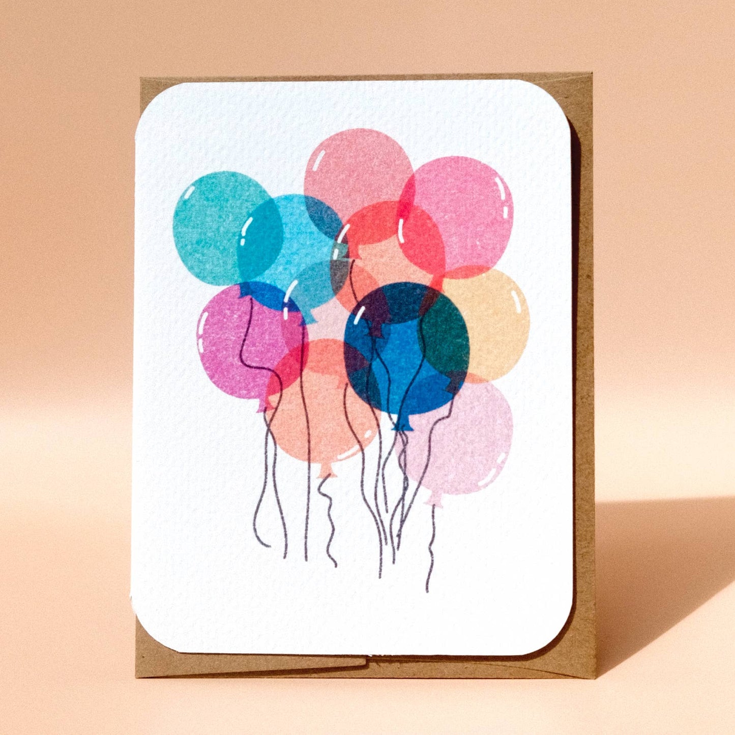 Greeting card with colorful balloons on a beige background