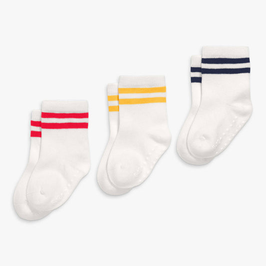 Three pairs of white socks with colorful stripes on a white background