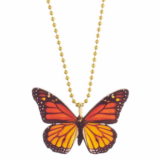 Butterfly-shaped pendant on a gold chain against a white background