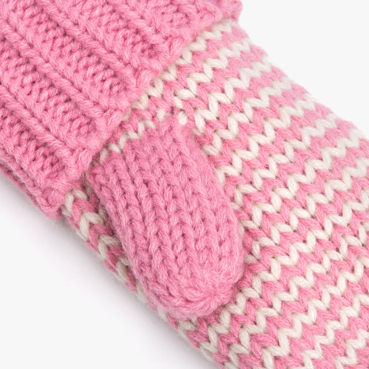 Close-up of a pink and off-white knit winter accessory, showing a ribbed cuff, a mitten-style thumb loop, and a wavy striped pattern on a plain light background.