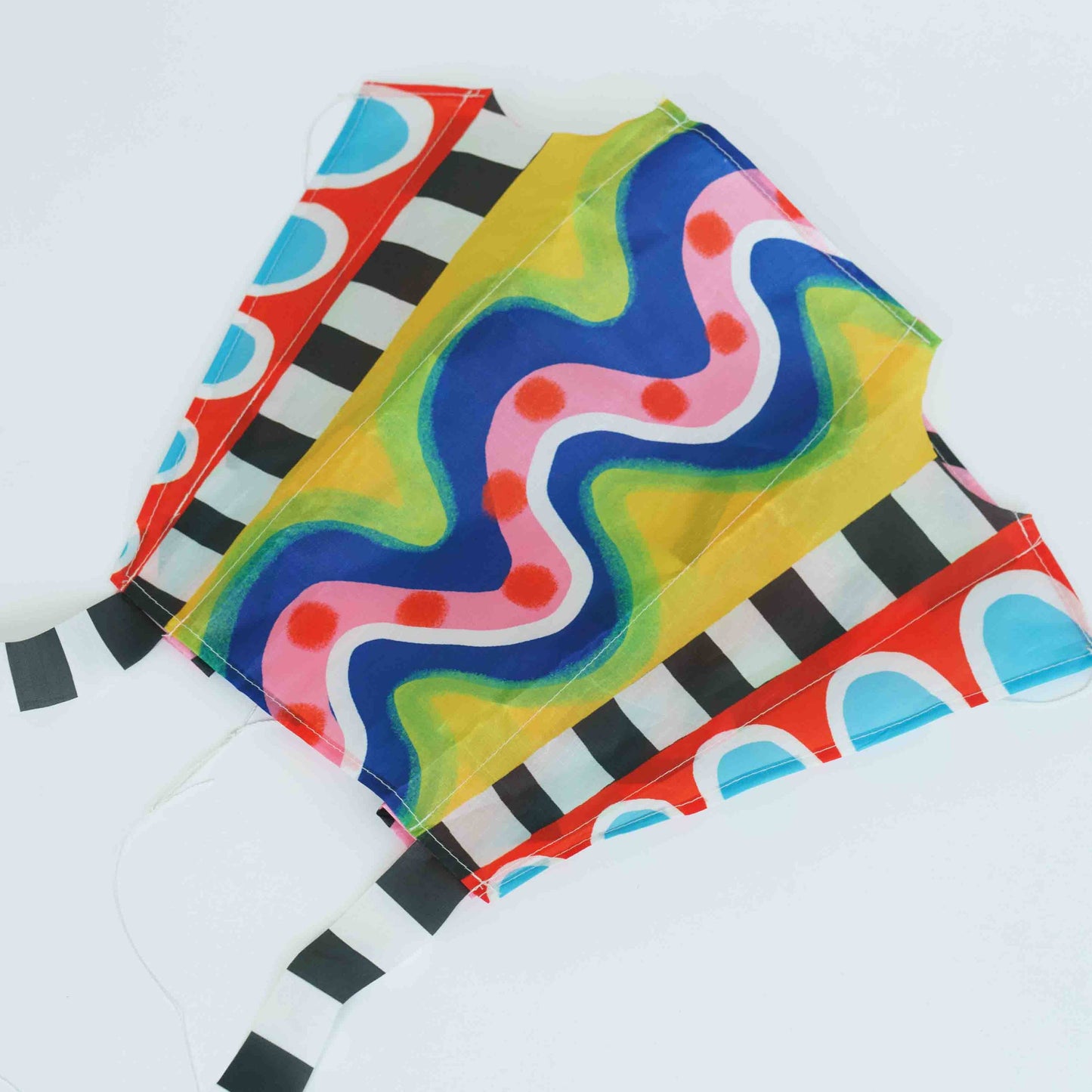 Colorful striped kite with wavy pattern on a white background