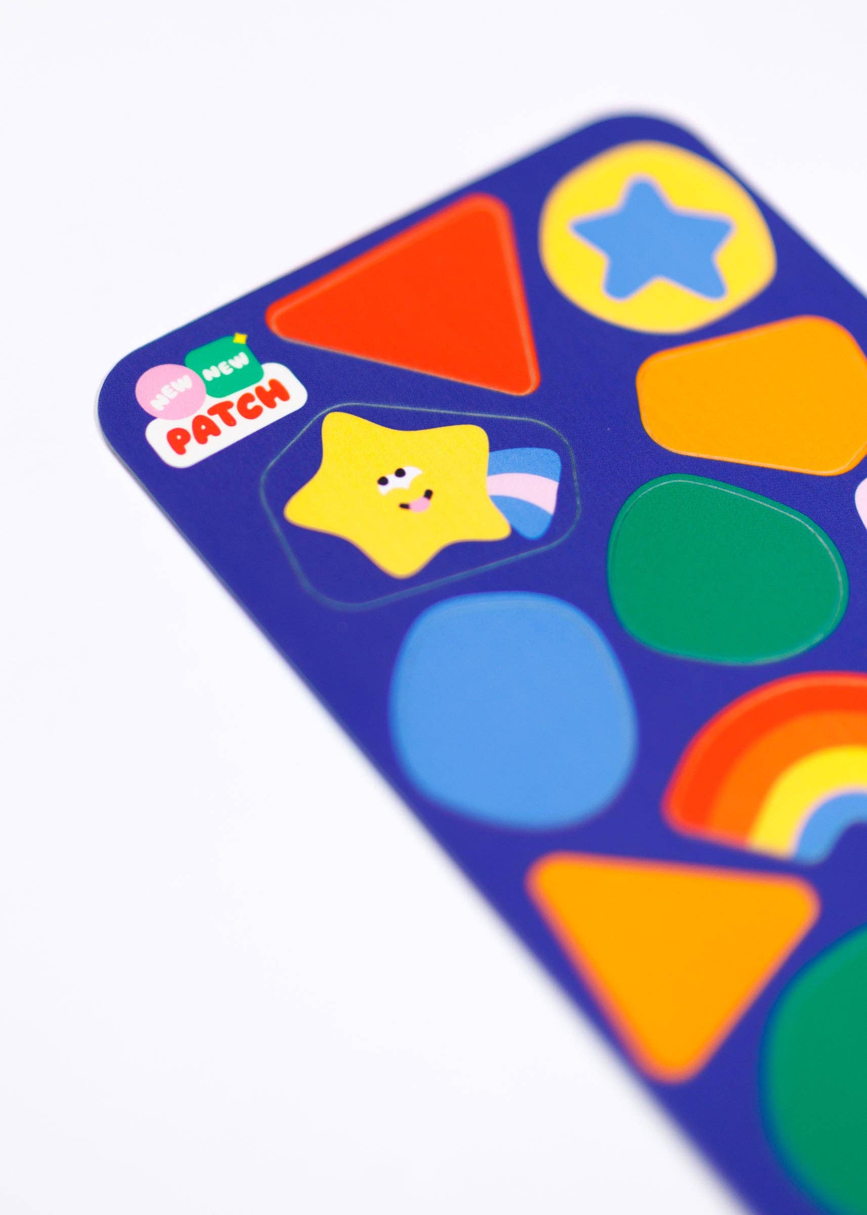 Colorful children's sticker patches with shapes and a brand logo on a white background