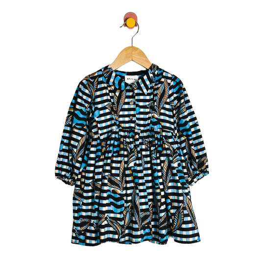 Patterned dress on a hanger against a white background