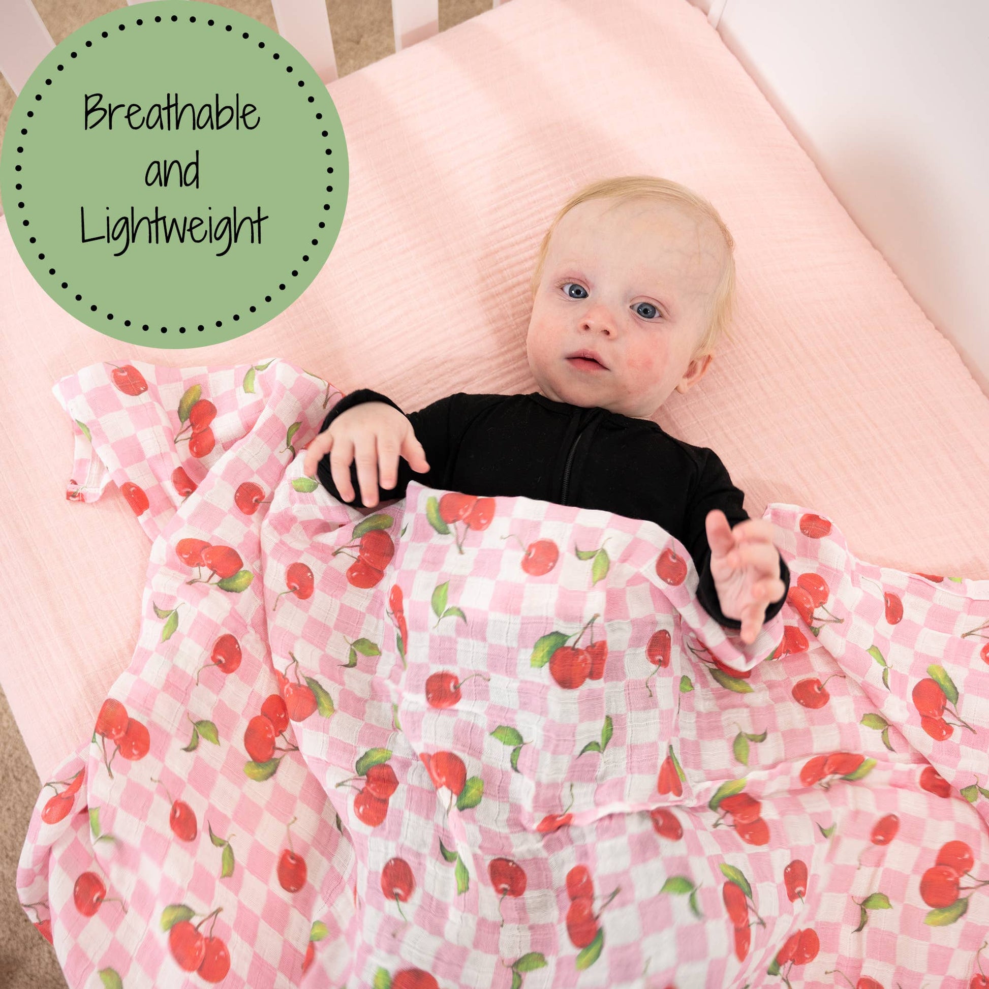 Baby lying on a pink blanket with cherry pattern, surrounded by text 'Breathable and Lightweight'.