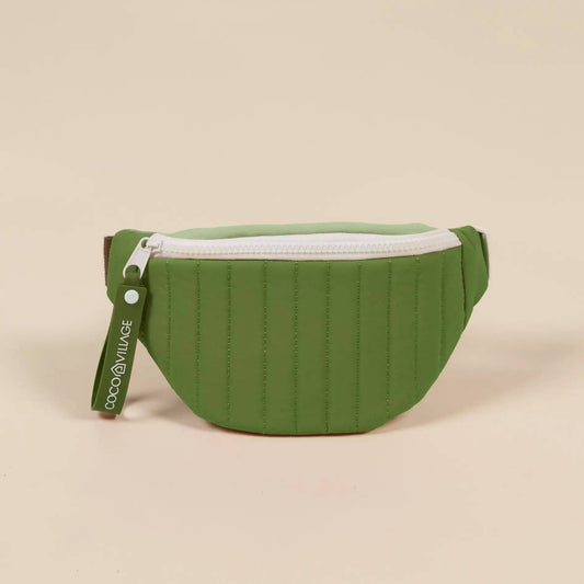 Green waist bag with a white zipper on a beige background