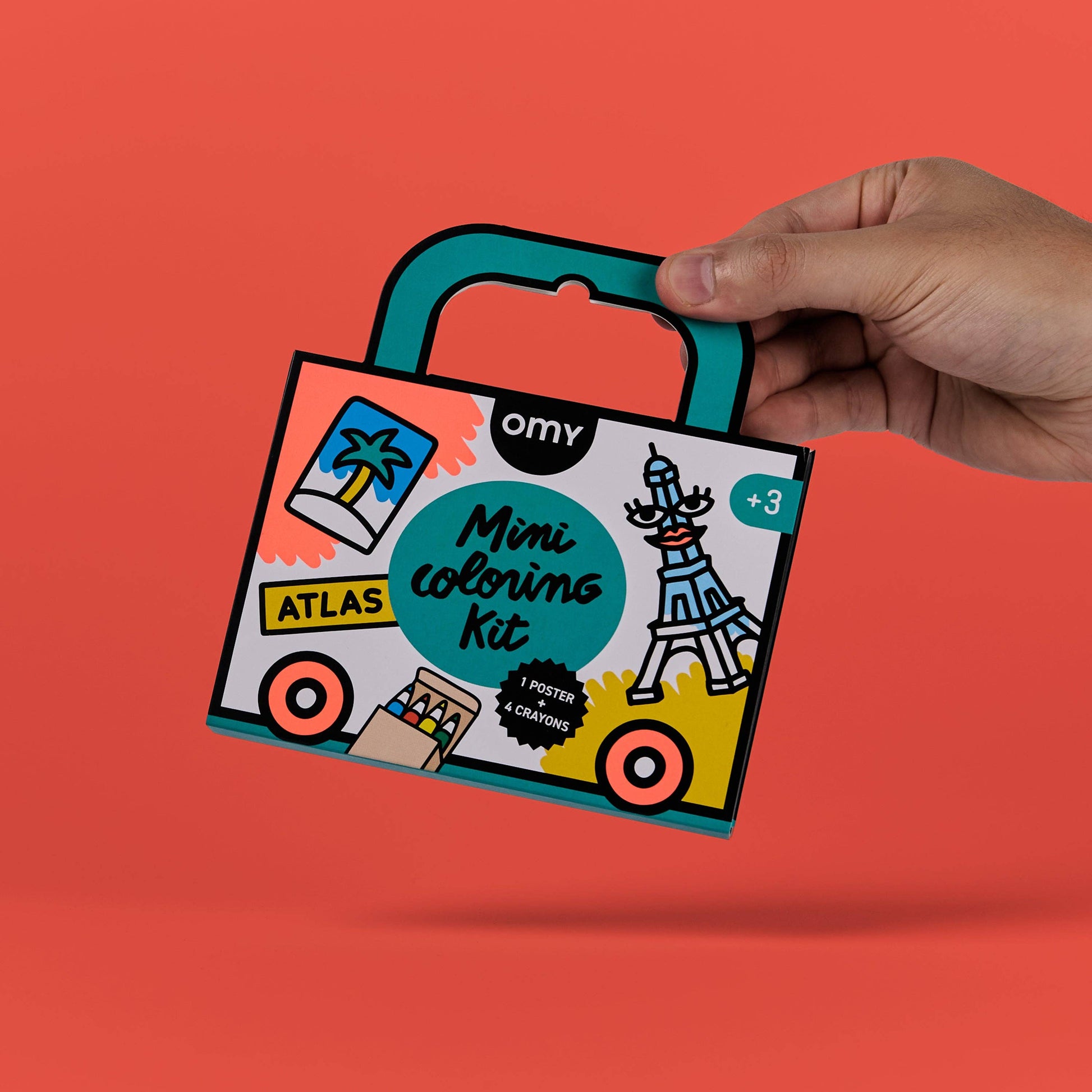 Hand holding a 'Mini Coloring Kit' against an orange background