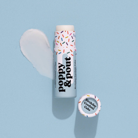 Lip balm with colorful sprinkles on a light blue background