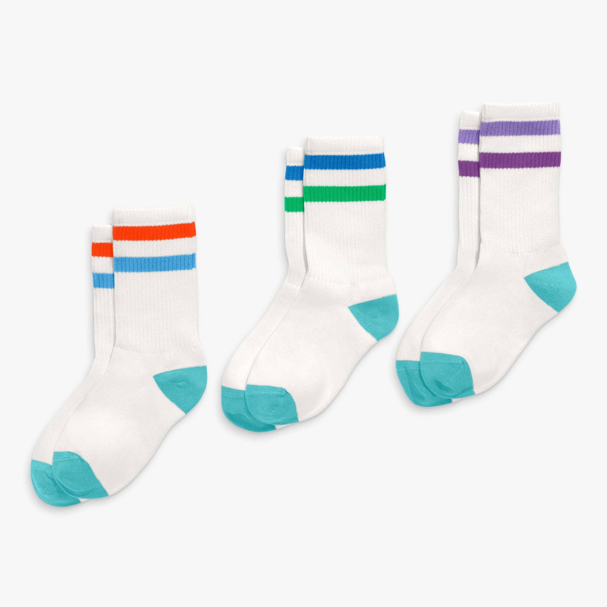 Three pairs of socks with colorful stripes on a white background