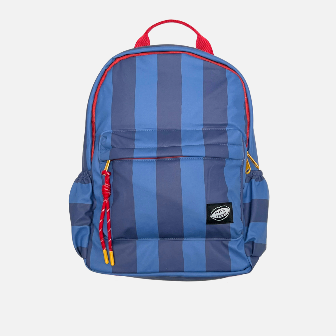 A child's backpack featuring vertical blue and navy stripes with red accents on the top handle, zipper trim, and drawstring cords, shown against a light gray background.
