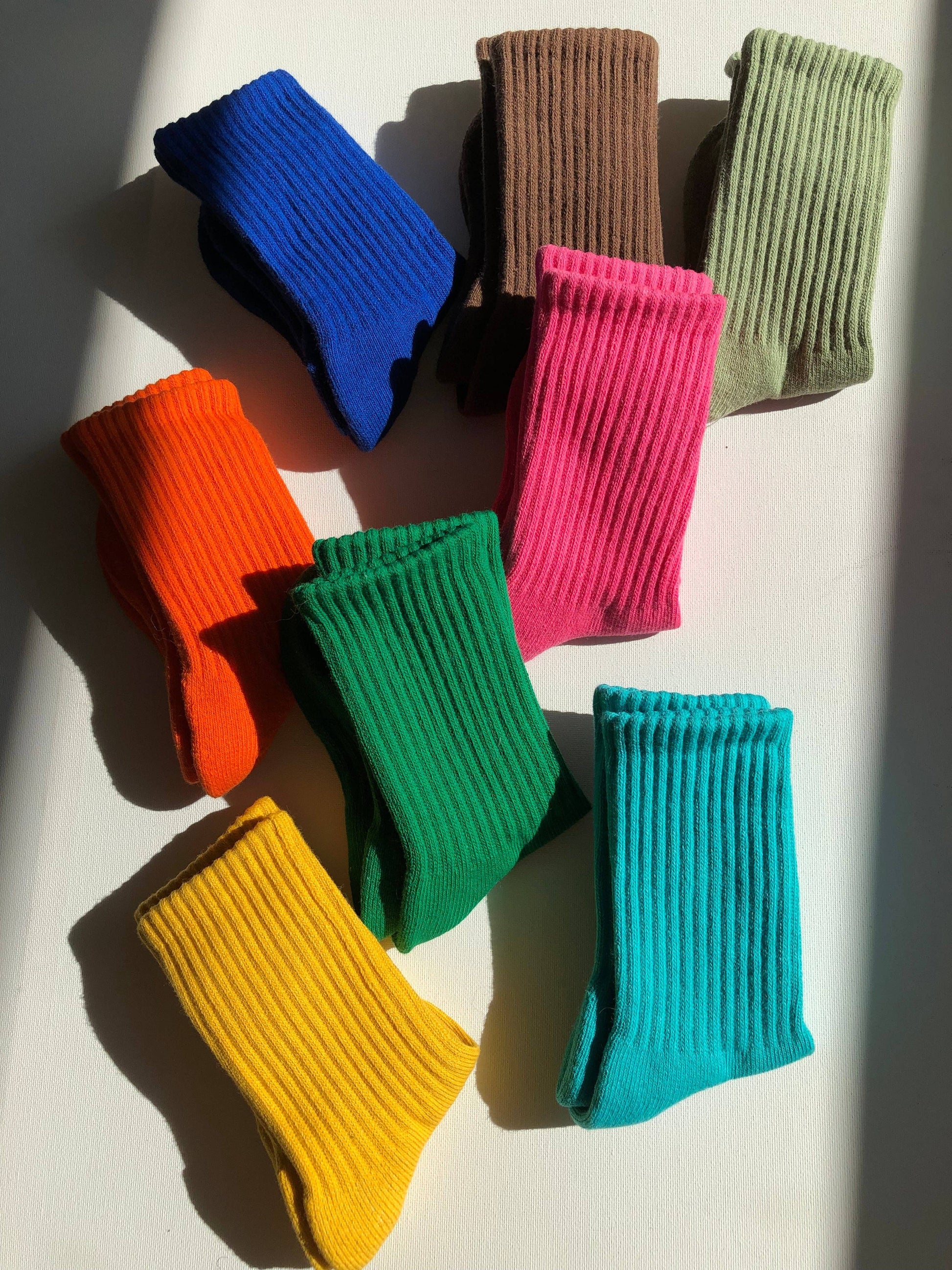 Colorful socks arranged on a white surface