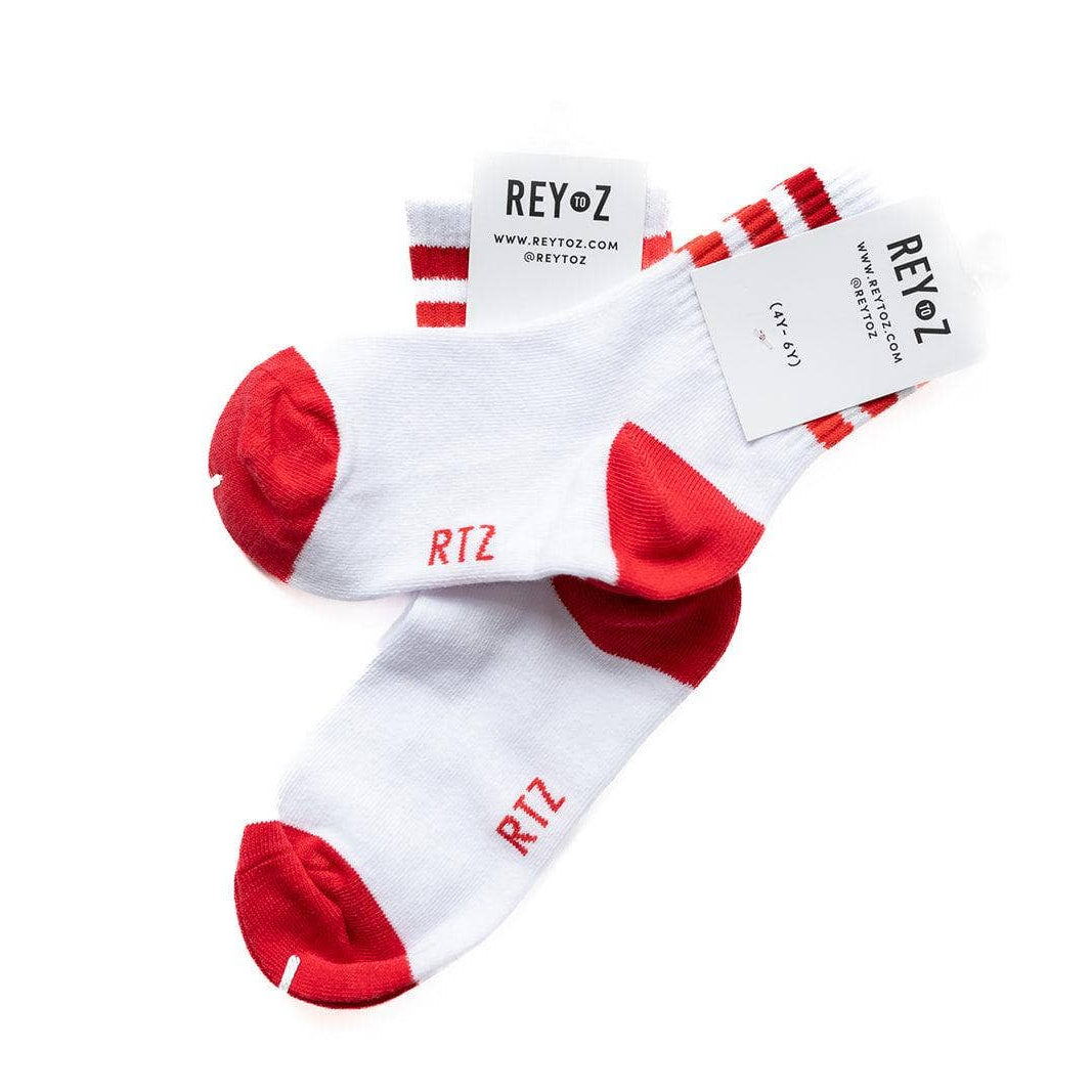 White socks with red toes and cuffs on a white background, featuring REYoz branding.