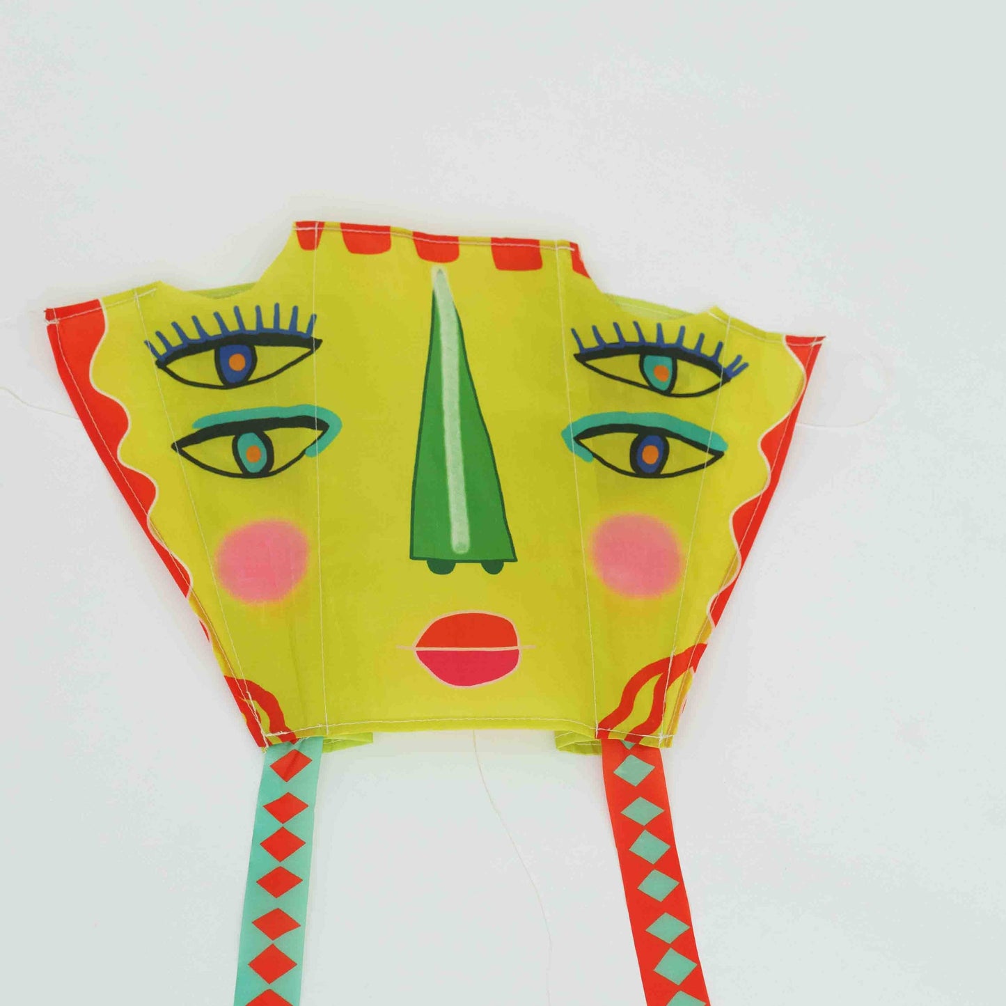 Colorful kite with abstract face design on a white background