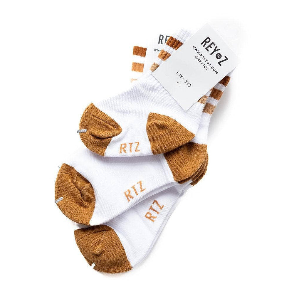 Pair of white socks with brown toes and heels, displayed on a white background.