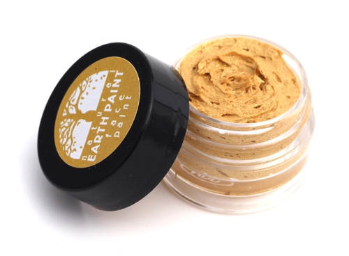 Cosmetic container with beige cream and black lid featuring 'Earth Paint' branding on a white background