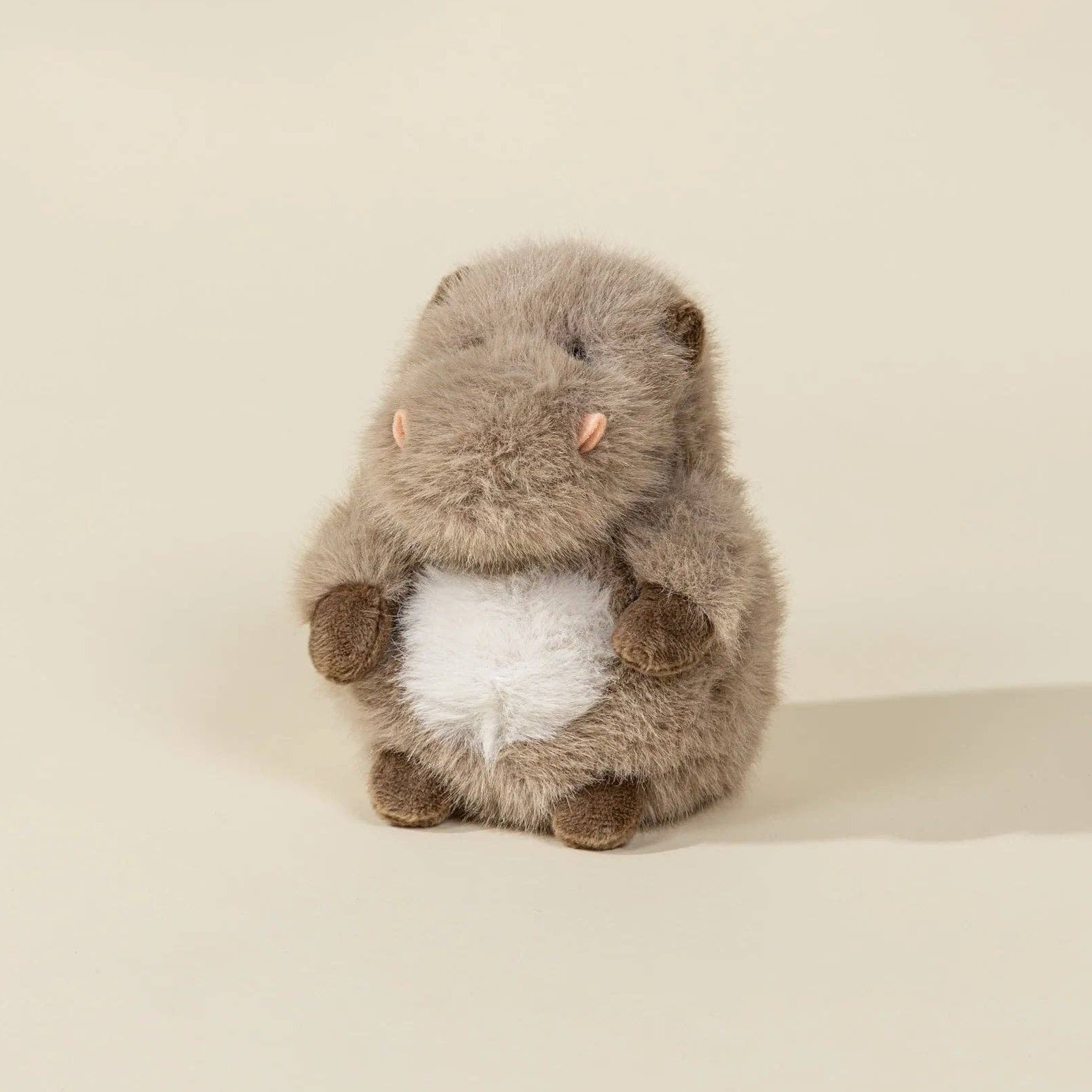 Plush toy resembling a beaver on a beige background
