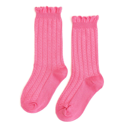 Pair of pink knee-high socks with ruffled top on a white background