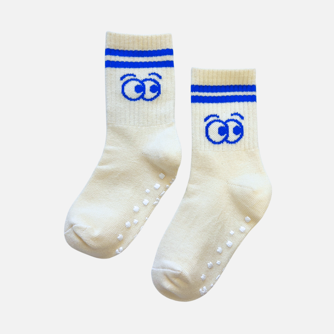 Pair of cream socks with blue accents and paw prints on a white background
