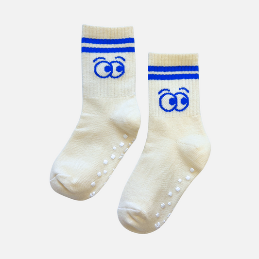 Pair of cream socks with blue accents and paw prints on a white background