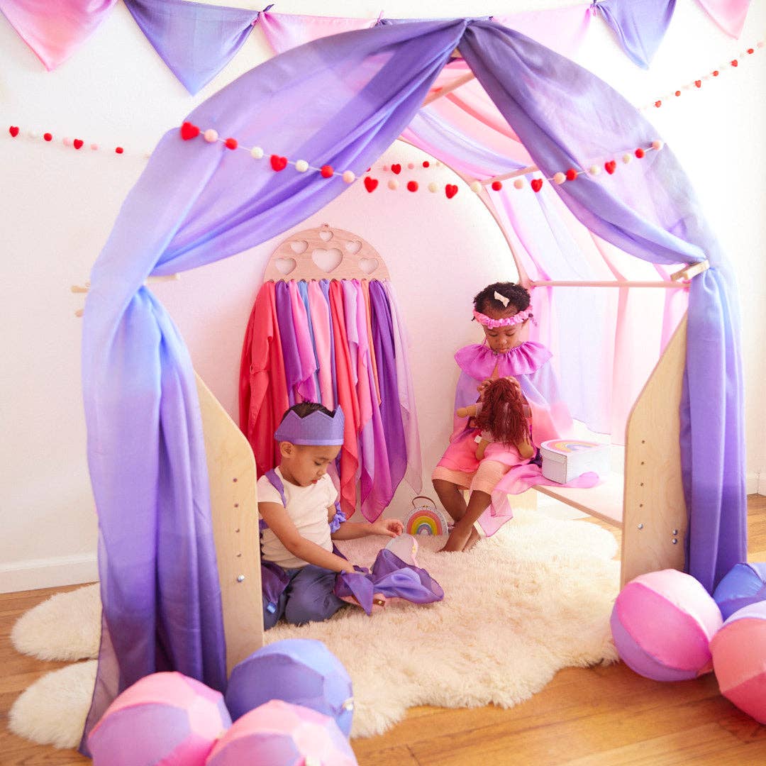 Children playing inside a colorful play tent with purple and pink accents.