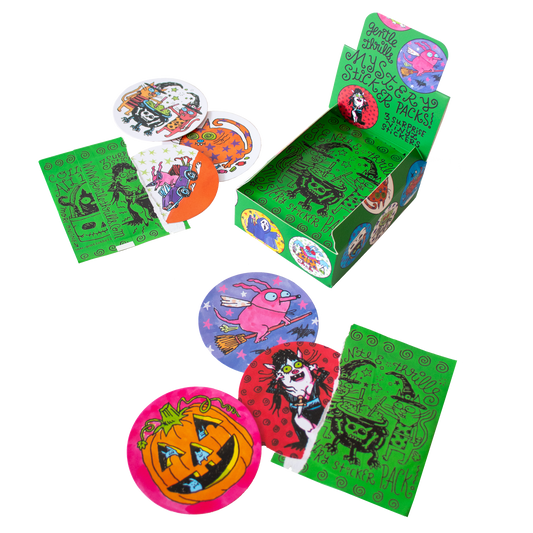 A Halloween-themed paper display box with printed graphics, surrounded by loose round stickers and green rectangular cards on a plain white background.
