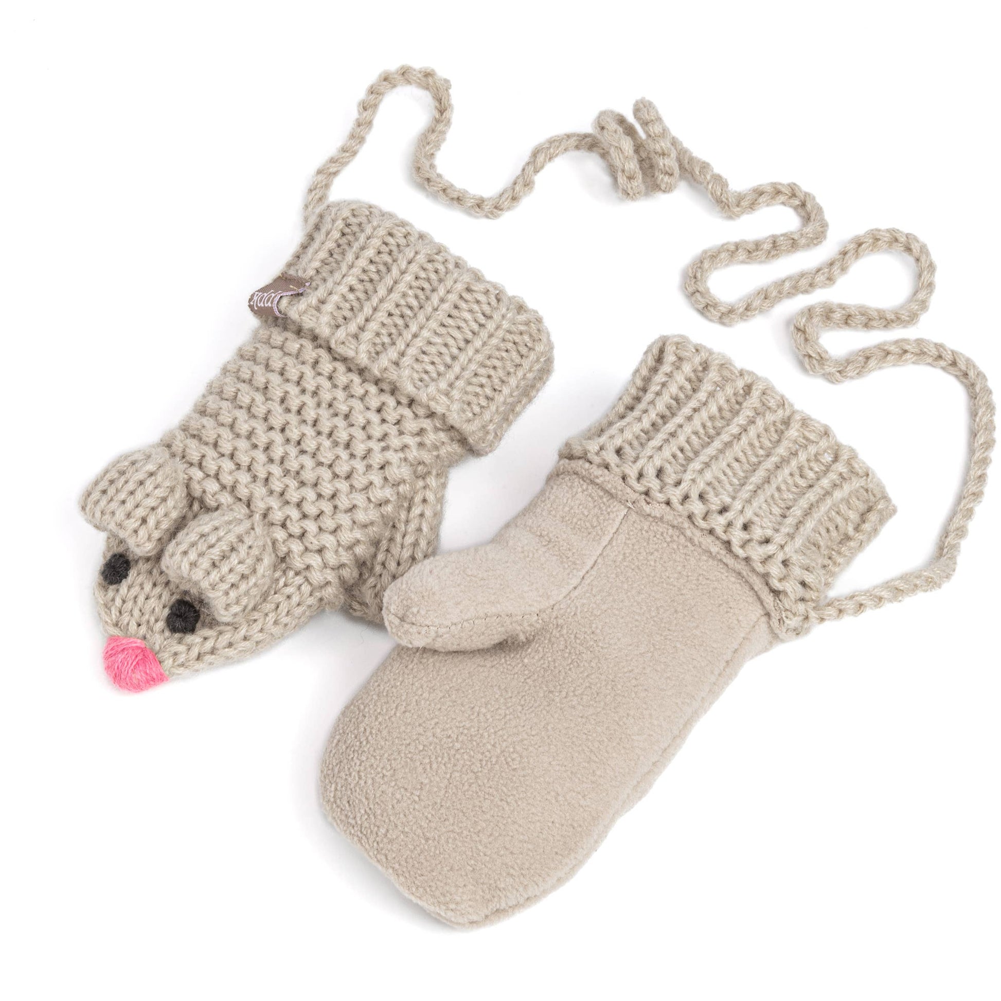 Pair of beige knitted mittens with a face design on a white background