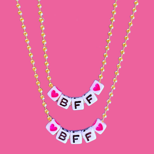Necklace with 'BFF' letters on a pink background