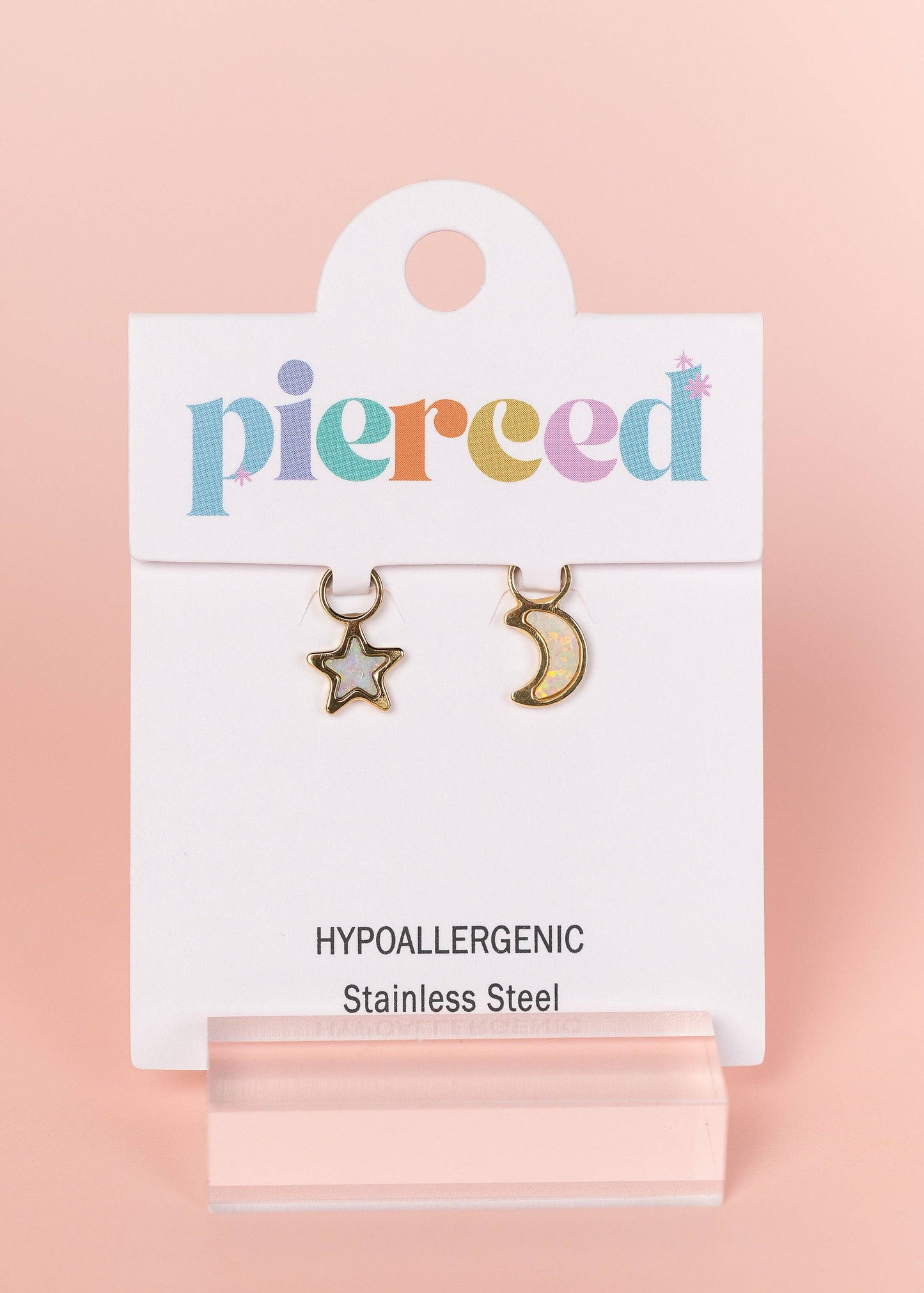 Earring card with star and moon earrings on a pink background