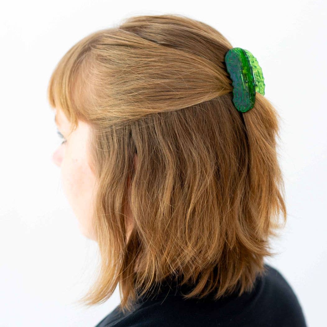 Person with a green hair accessory in their hair on a white background