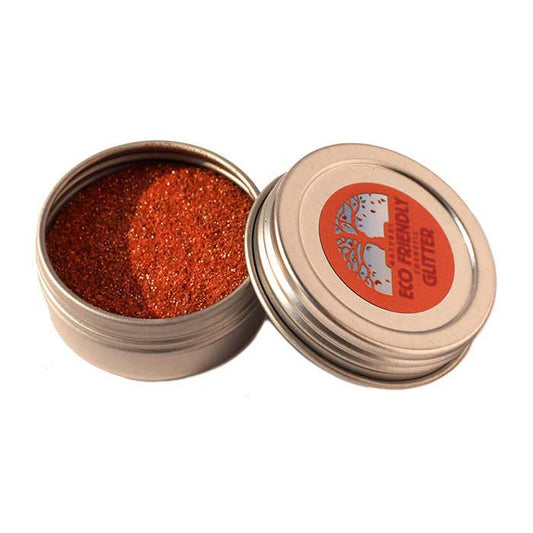 Open container of red glitter with a visible brand label on a white background