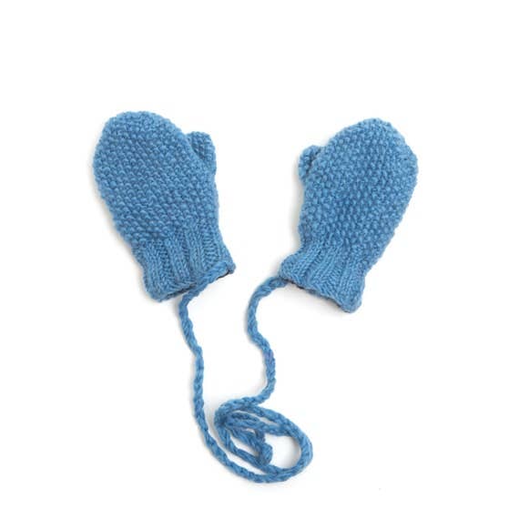 Pair of blue knitted baby mittens with strings on a white background