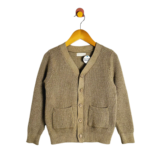 Brown cardigan on a hanger against a white background