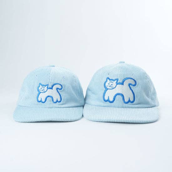 Two light blue caps with cat illustrations on a white background