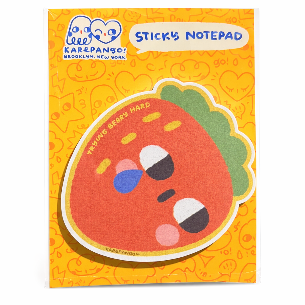 Sticky notepad with a cartoon strawberry design on an orange background, featuring the brand 'Kare & Pango'.