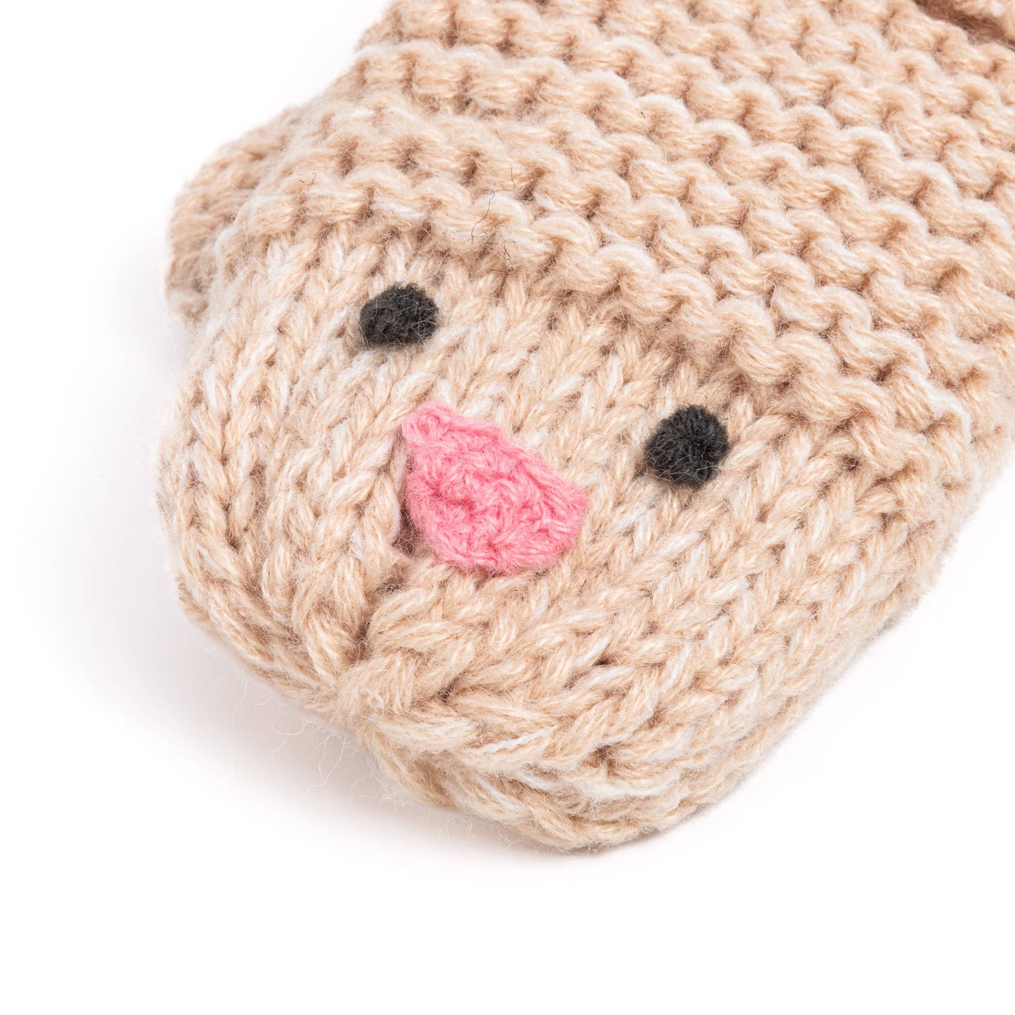 Knitted mitten with a pink nose and black eyes on a white background