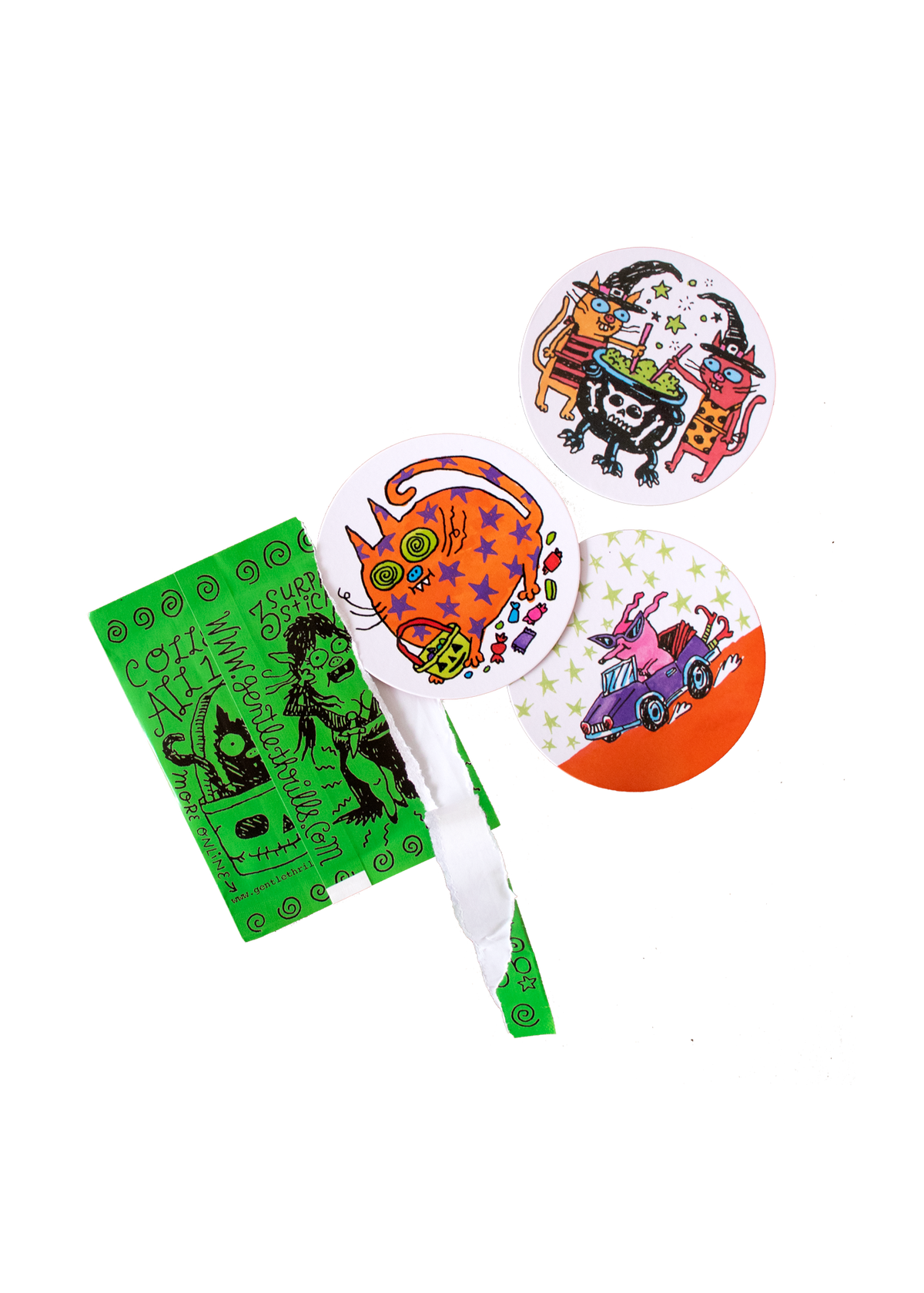 Three round Halloween-themed stickers with colorful cartoon designs and a green printed backing card, shown on a plain white background.