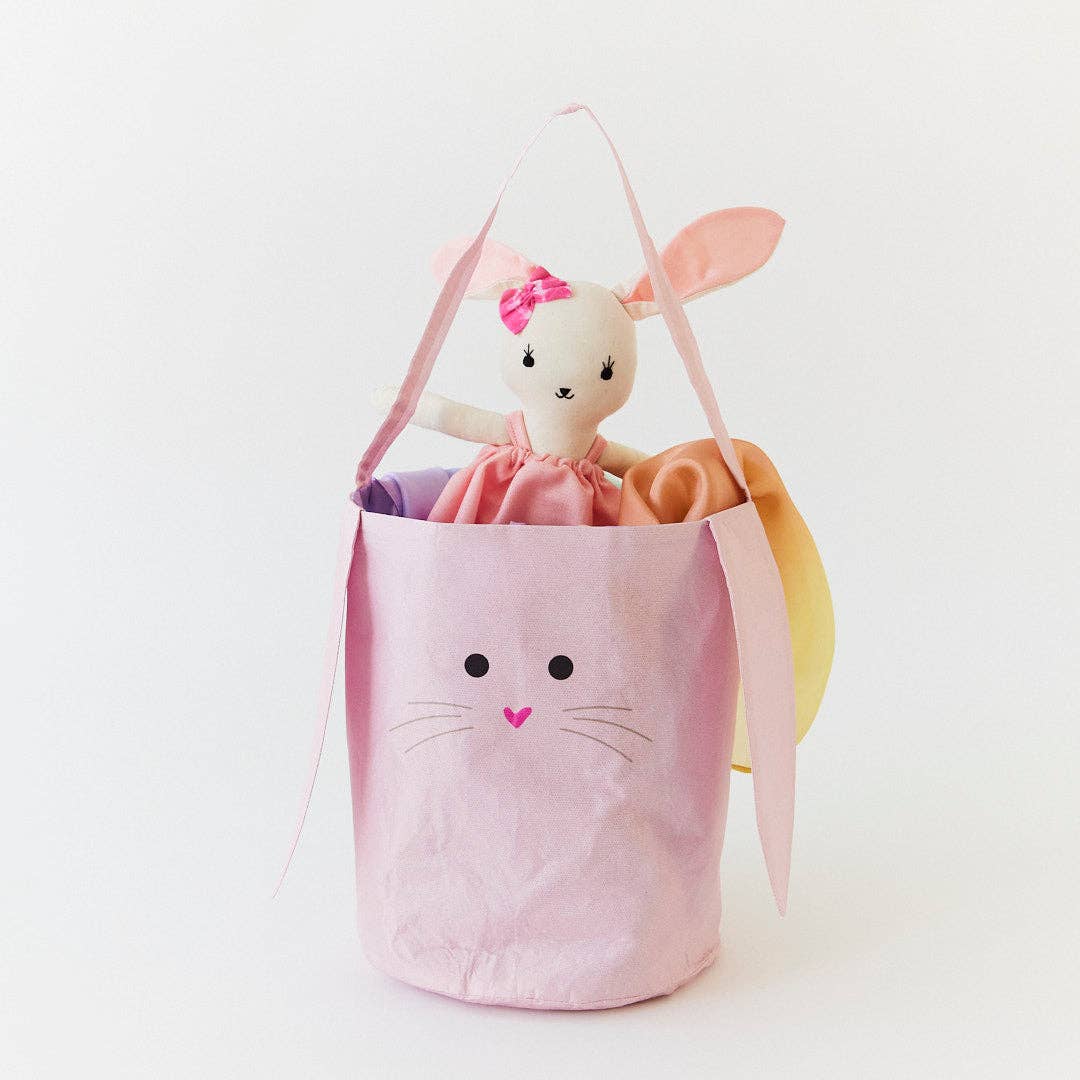 Pink bunny-shaped bag with a plush toy inside on a white background