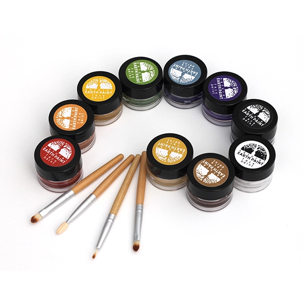 Set of makeup jars with lids and brushes on a white background