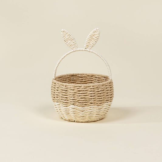 Woven basket with bunny ears on a beige background