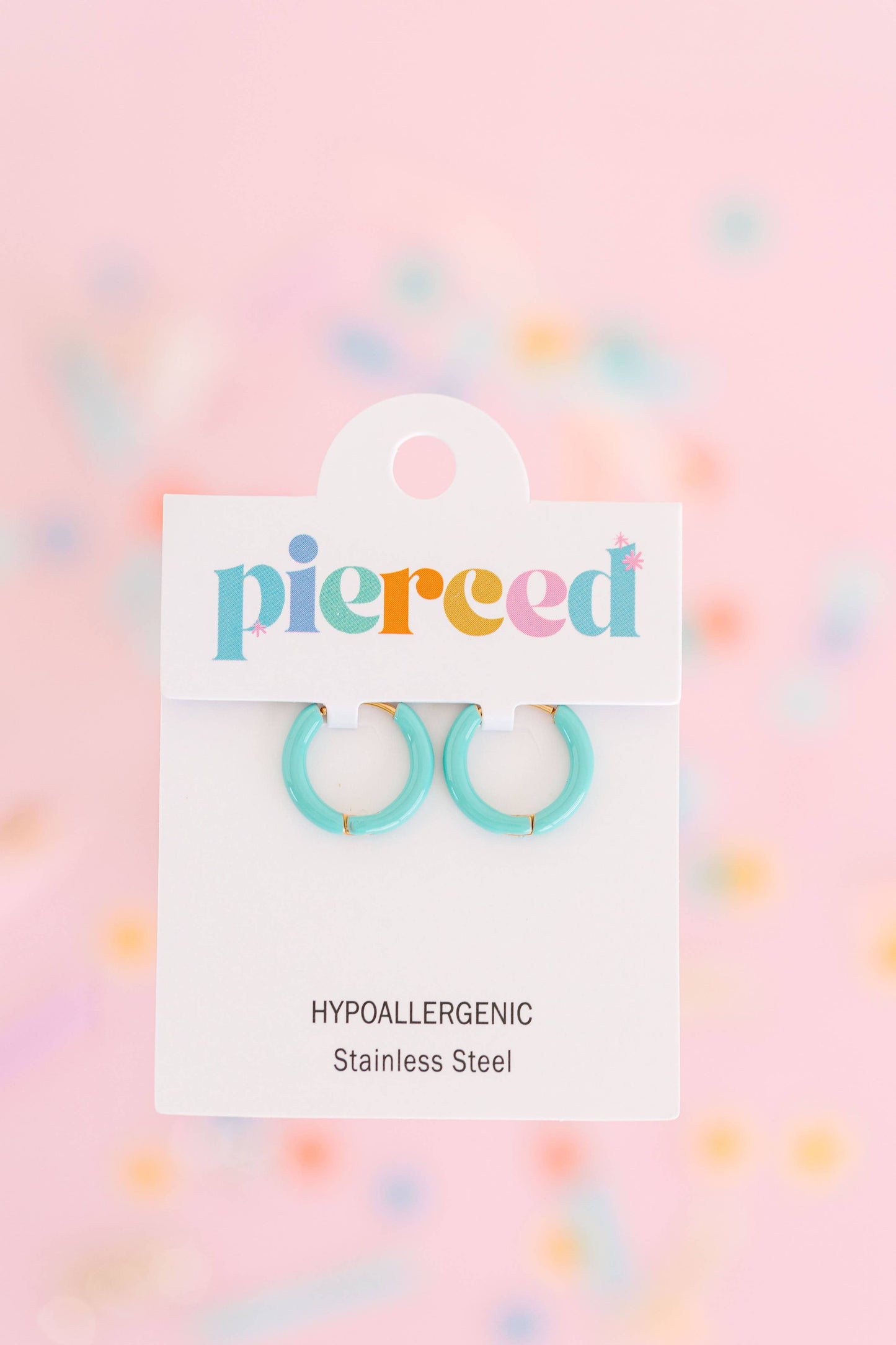 Turquoise hoop earrings on a 'pierceed' branded card with a colorful polka dot background.