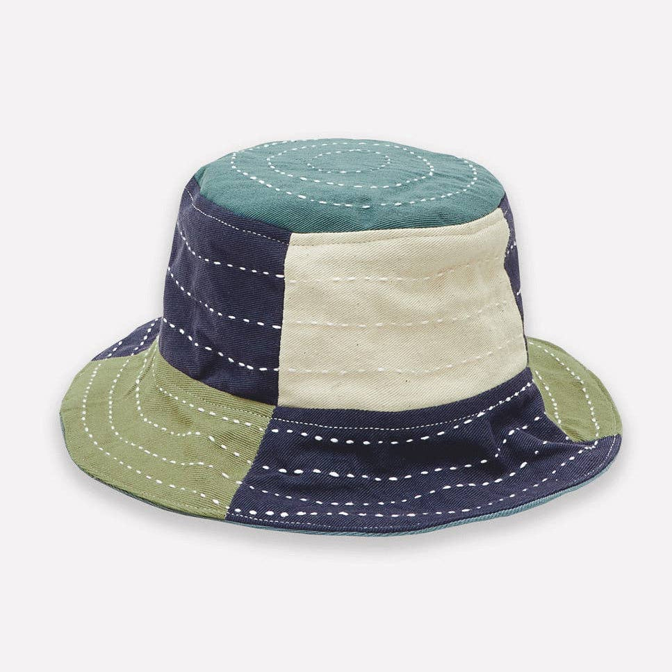 Color-blocked bucket hat with green, blue, and beige sections on a white background